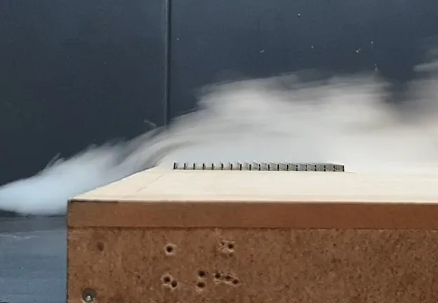 Scale model of vertical PV units under test in a wind tunnel laboratory
