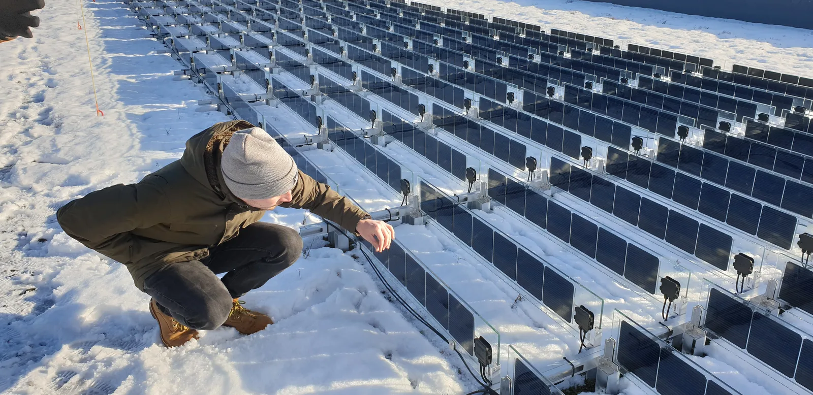 Vertical solar panels mounted on a reflective roof surface